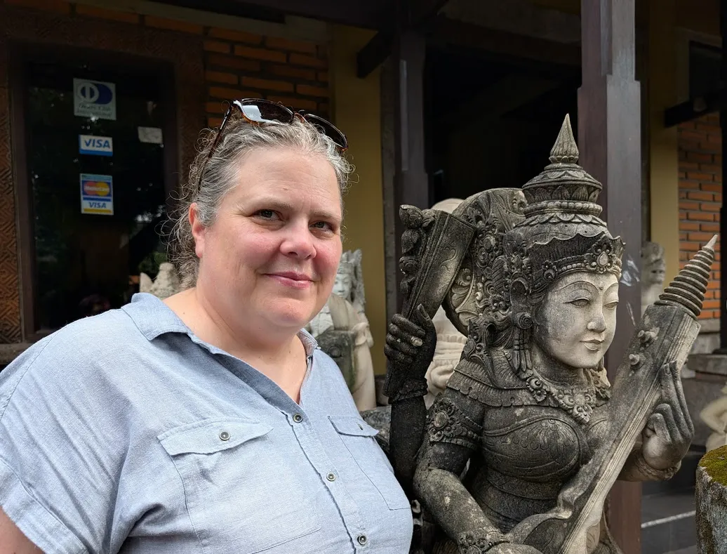 Chrissy and a statue of Saraswati.