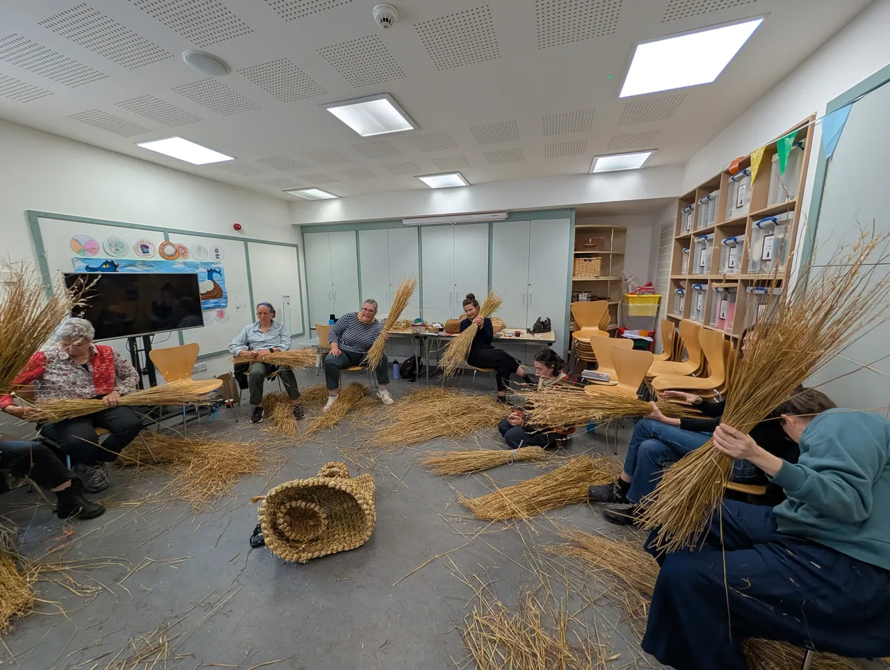 Straw being prepared. We needed to split a big sheaf into fourteen equal piles. The way I tried to communicate this is: Split it in half first, then for each half, do a tower of hanoi operation. Split sheaf in half, take right half and split in half again, and once again. Now you have sheaves of size 4, 2, 1, 1. Take one of the 1s and spit it the same way, giving a 1/2, 1/4, 1/8, 1/8. Put the 1/2 with the 4, the 1/4 with the 2 and the 1/8 with the 1. Take the extra 1/8, and really that’s just a couple of straws, so do whatever. Now you’ve evenly spread 1/8th throughout the big bundle, and you can split the 2 and 4 bundles down into 1s and you have 7 total bundles (each about the same size, since you spread one of the 8 potential bundles proportionally into the 4, 2, and 1 bundle. Repeat for the other big bundle.