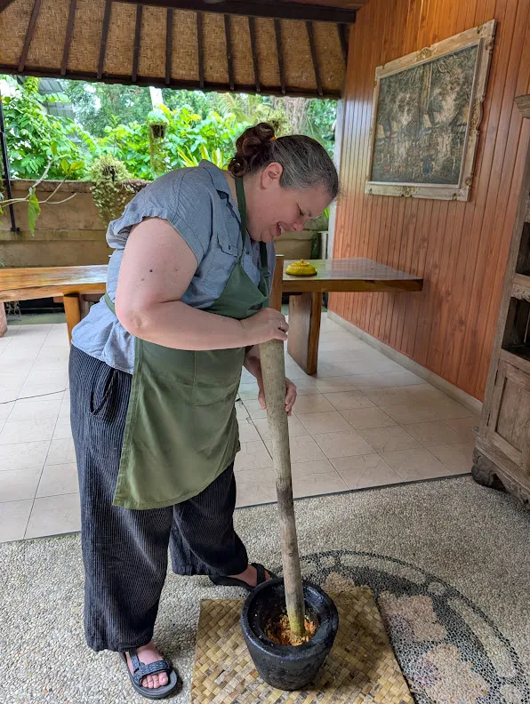 Chrissy working a Bali Blender. The chopped ingredients to the mother yellow sauce get worked into a paste in the mortar. Or pestle. I forget which is which.